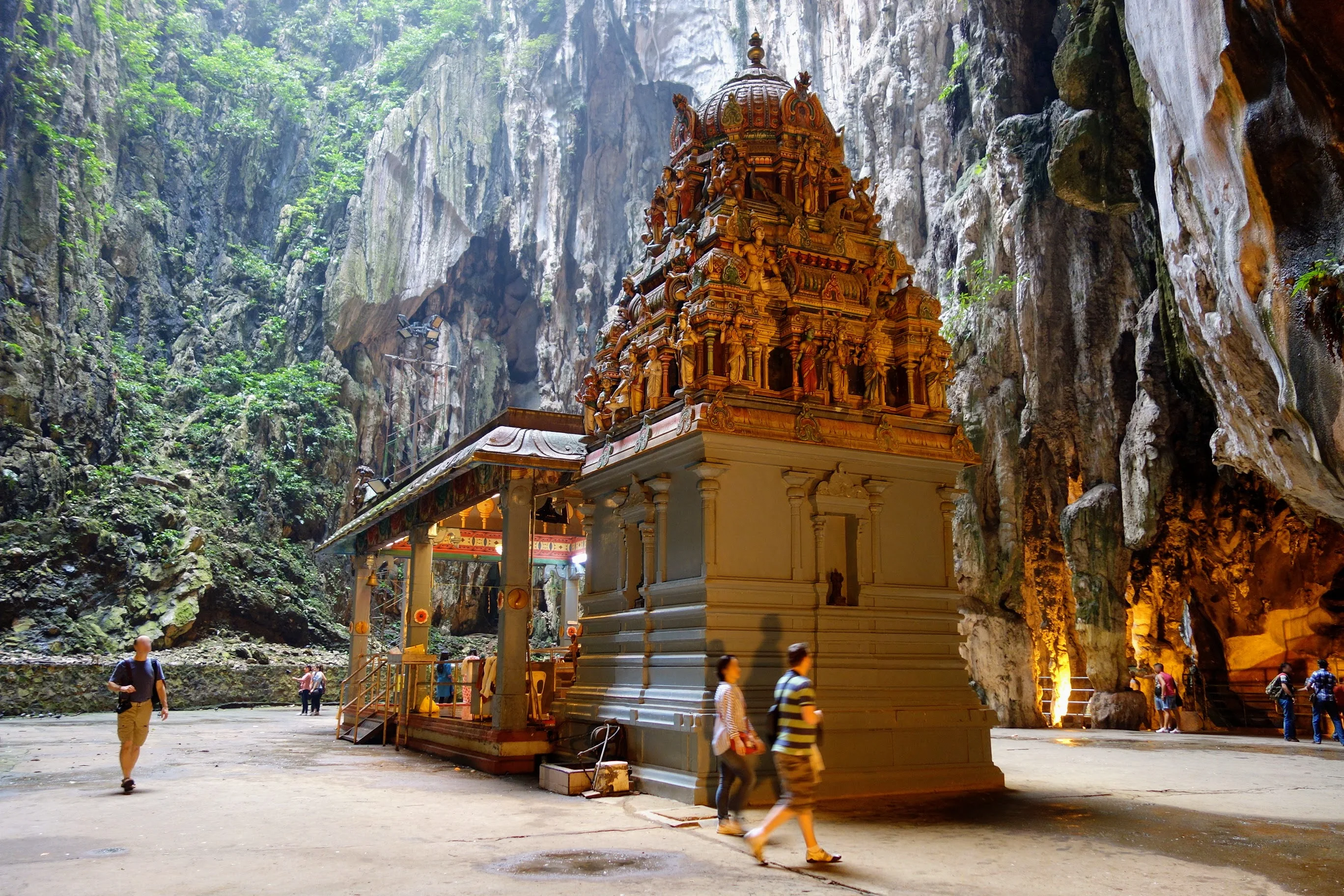 Decorated Hindu shrine against the limestone wall inside Batu Caves Temple Cave