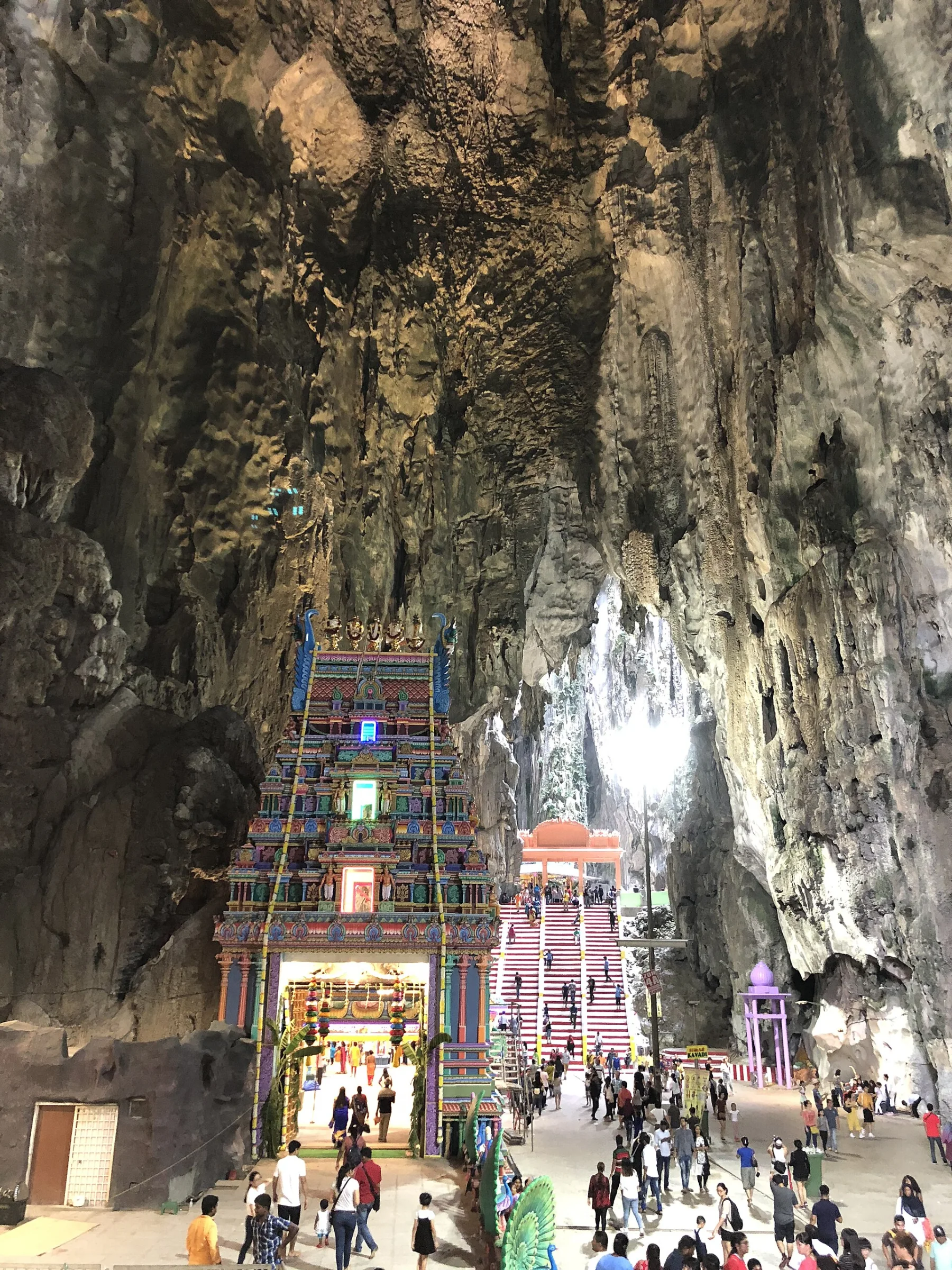 Limestone interior of Temple Cave, with a shrine, stairs and daylight entering above