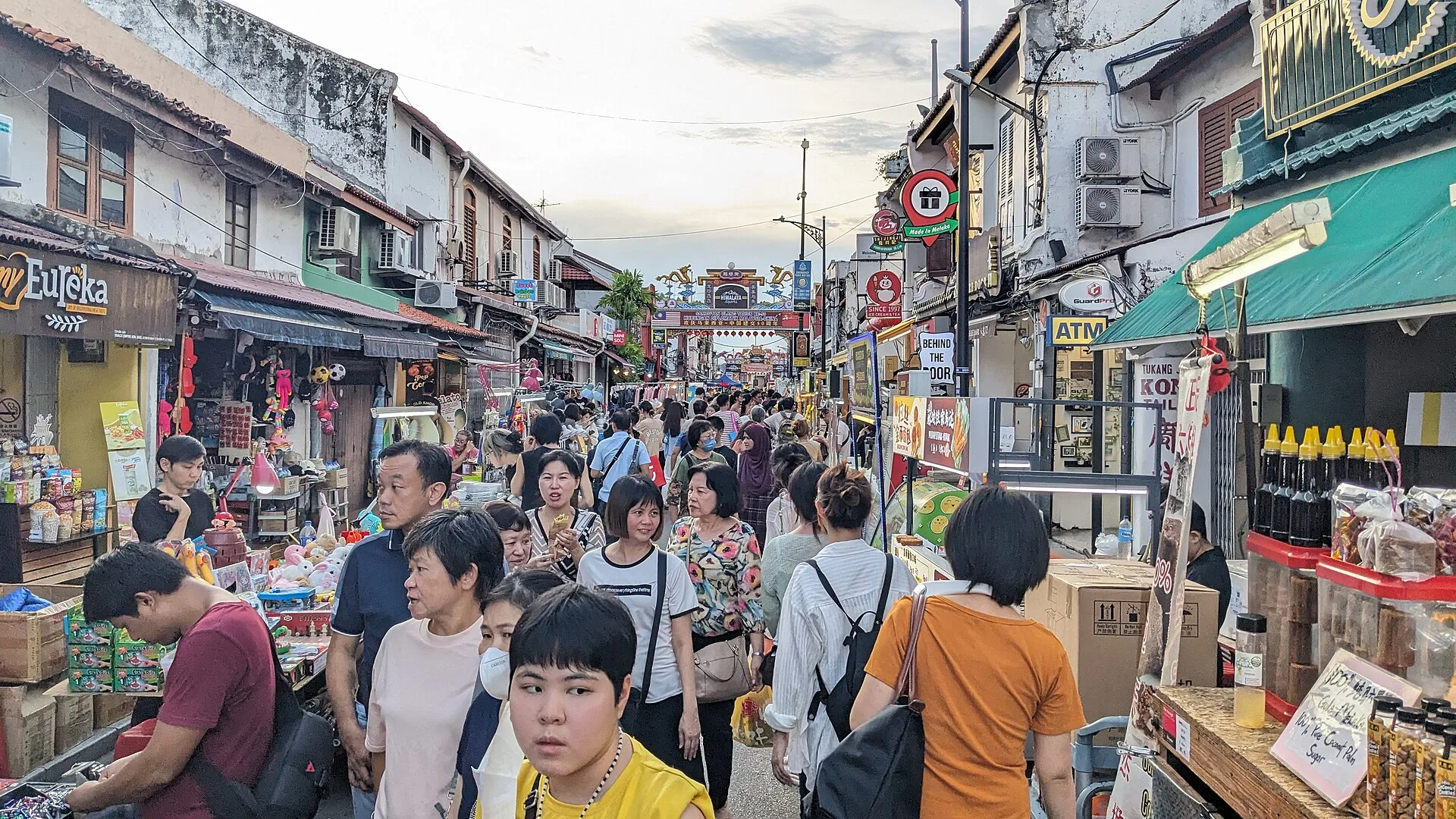 People and stalls along Jonker Street in the evening
