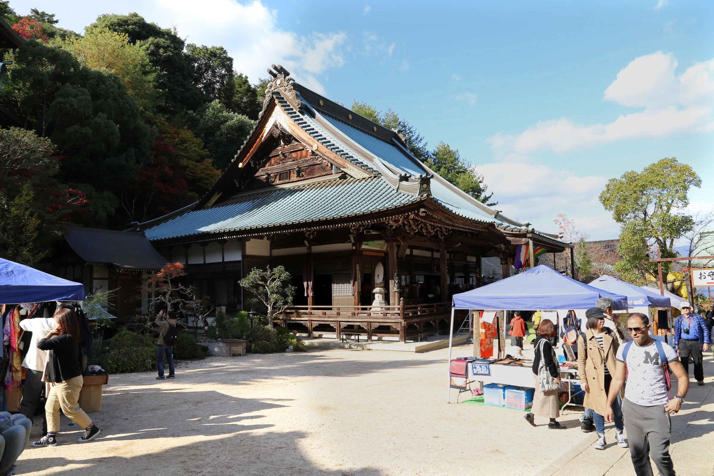 The timber hall of Daisho-in against a wooded slope, seen across the courtyard