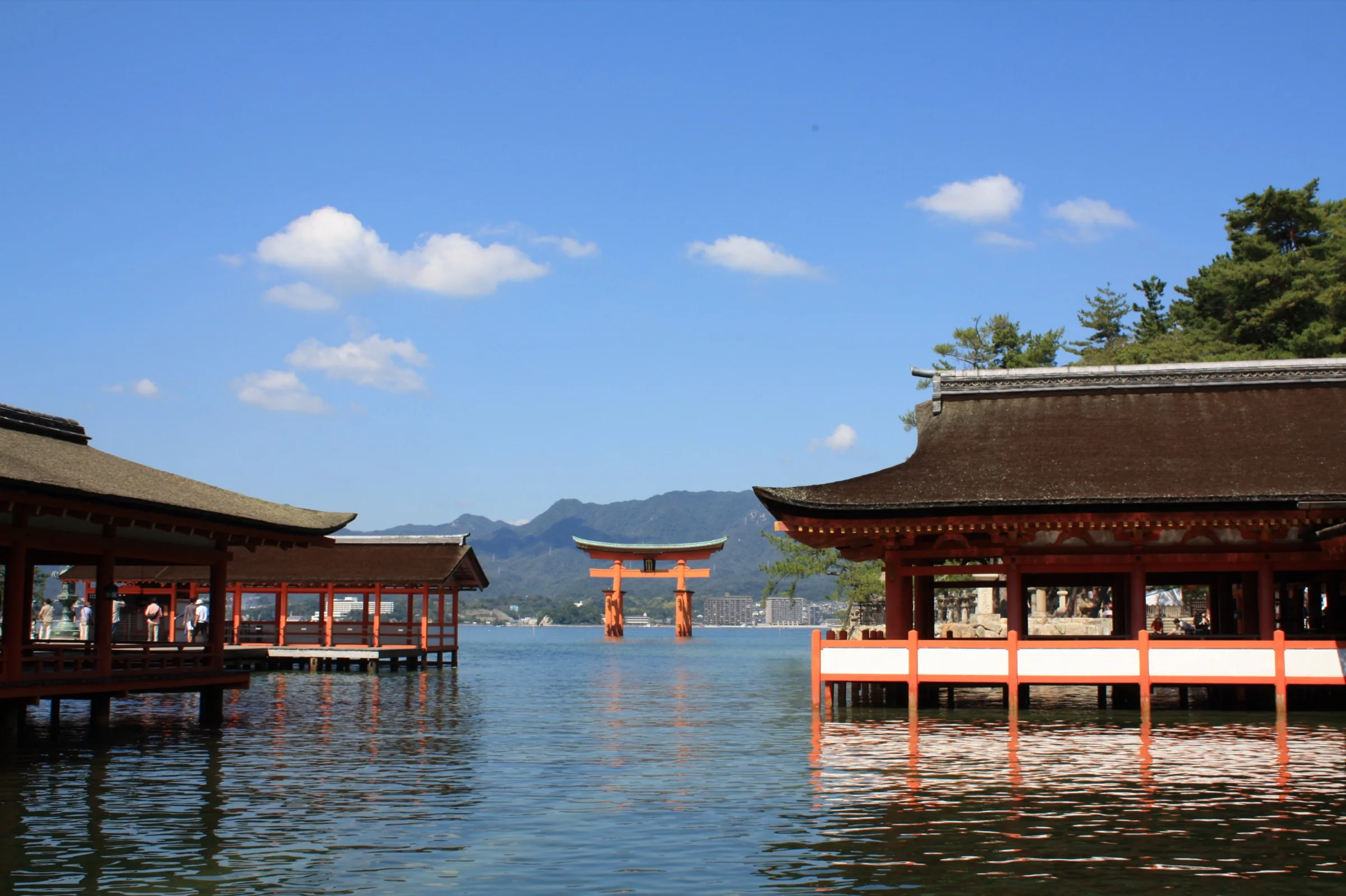 Itsukushima Shrine’s vermilion halls over the water, with the great torii standing offshore