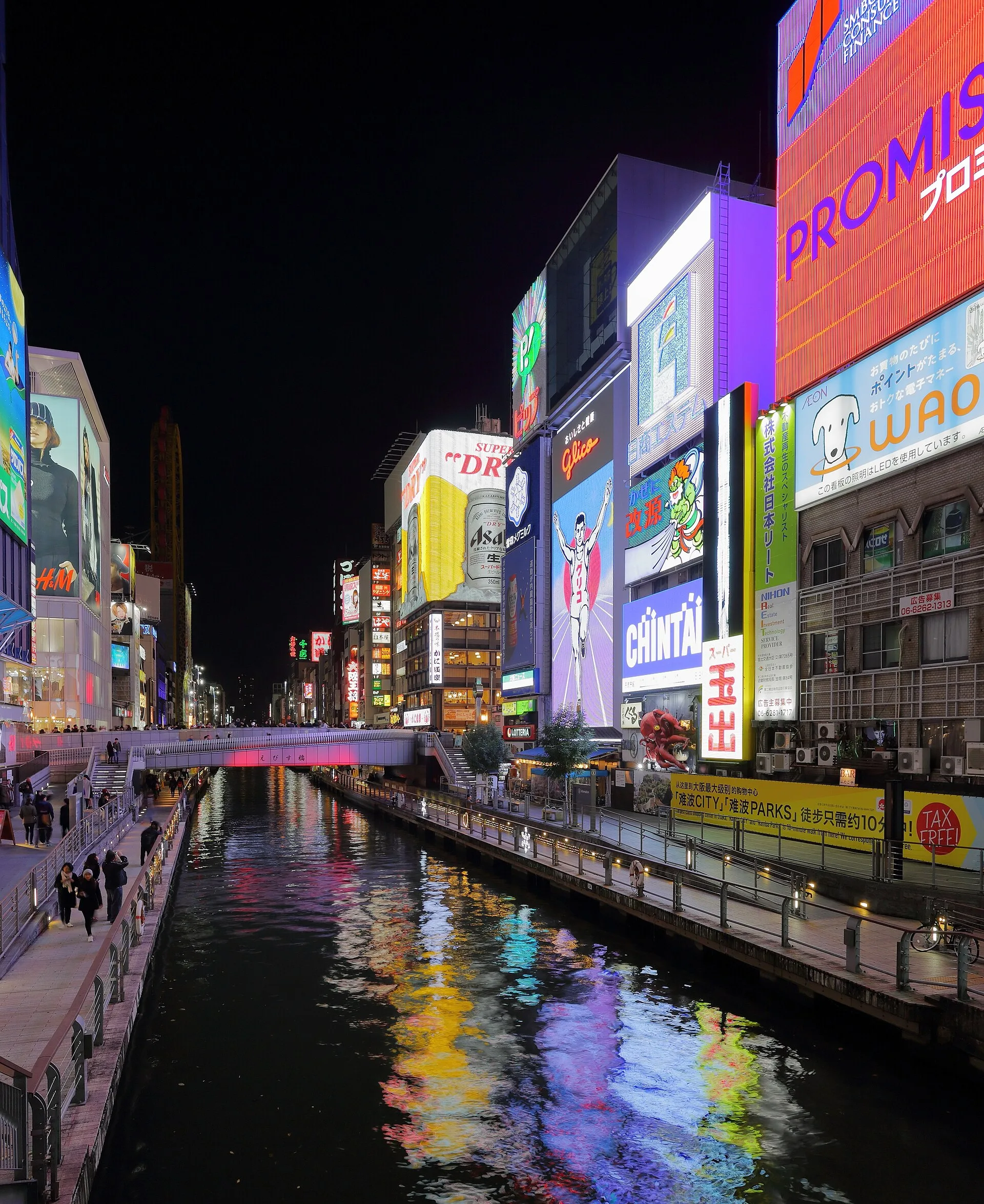 Dotonbori Canal and the riverside walk beneath illuminated signs