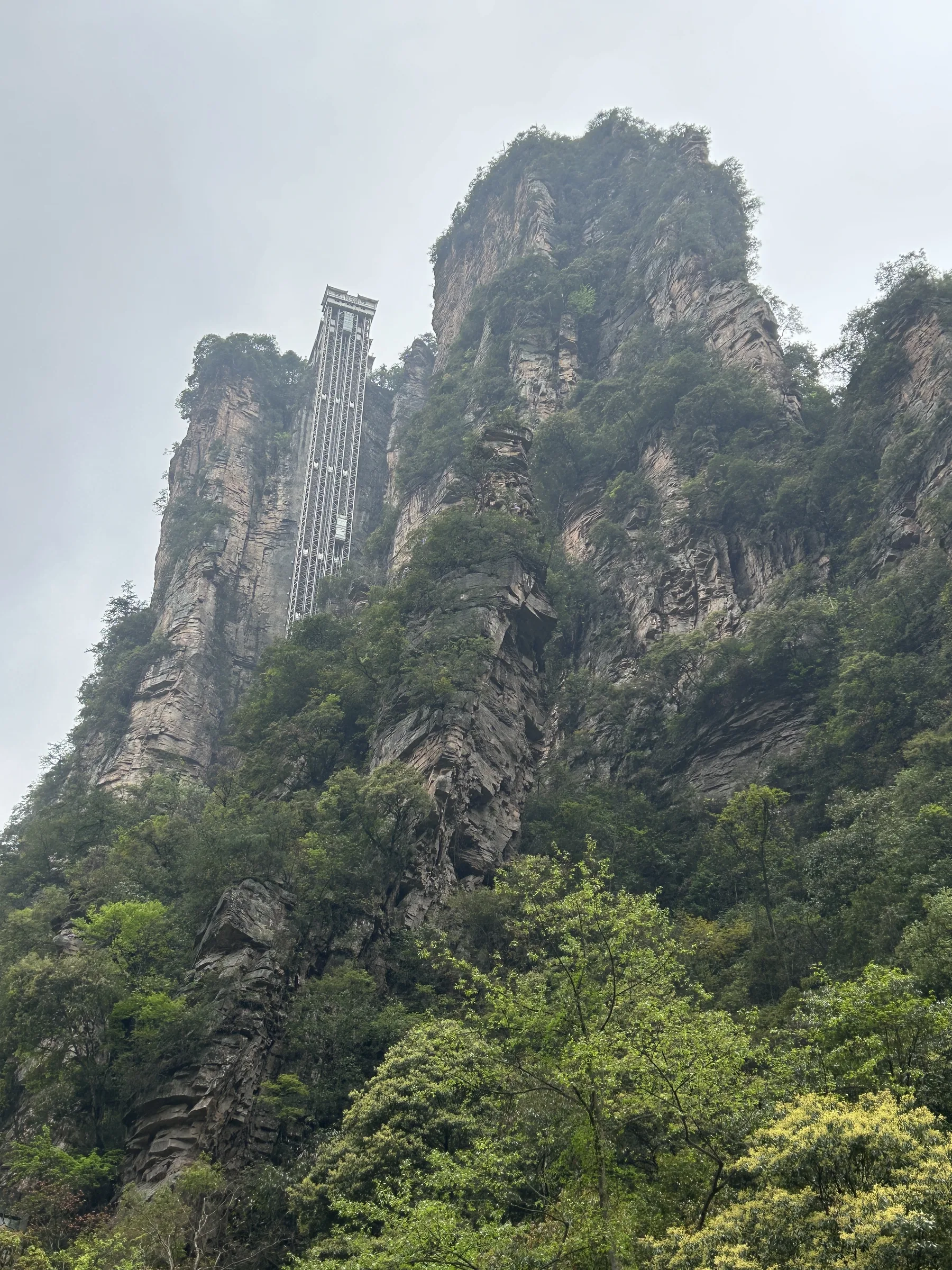 The Bailong Elevator shaft rising against a sandstone cliff in Wulingyuan